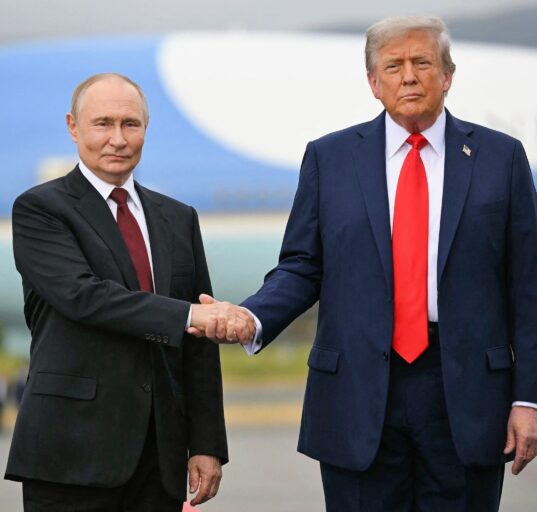Donald Trump and Vladimir Putin walking side-by-side at the Alaska summit.