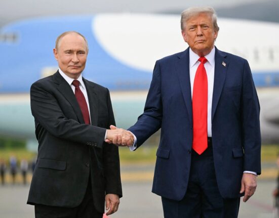 Donald Trump and Vladimir Putin walking side-by-side at the Alaska summit.