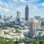 A breathtaking aerial view of the Atlanta skyline with high-rise buildings under a clear blue sky.