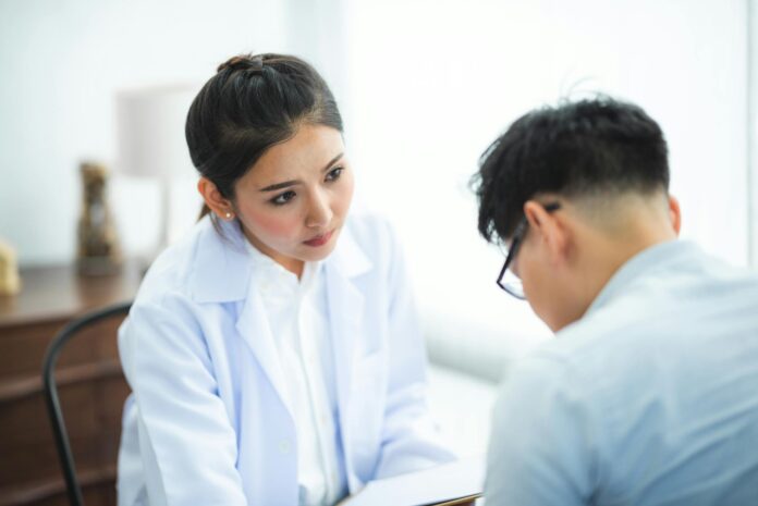 A doctor attentively listens to a patient during a medical consultation, emphasizing care and understanding.