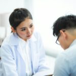 A doctor attentively listens to a patient during a medical consultation, emphasizing care and understanding.